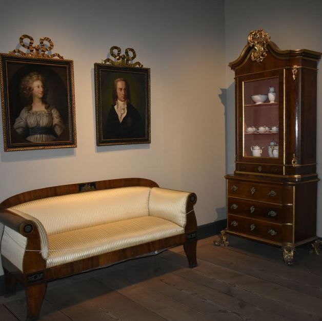 Sønderborg Slot.
En stue med smukke møbler og portrætter.